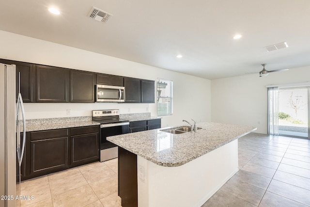 kitchen with stainless steel appliances, visible vents, a sink, and light tile patterned flooring