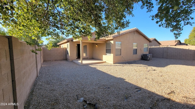 rear view of property featuring a patio area and cooling unit