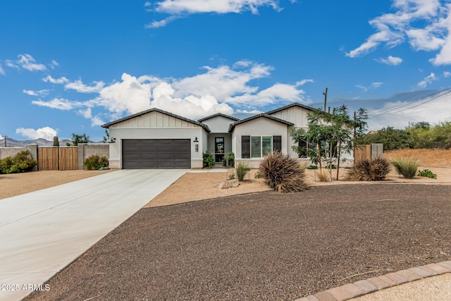 5670 E Singletree St, Apache Junction, AZ 85119 - view of front of home with a garage, driveway, board and batten siding, and stucco siding