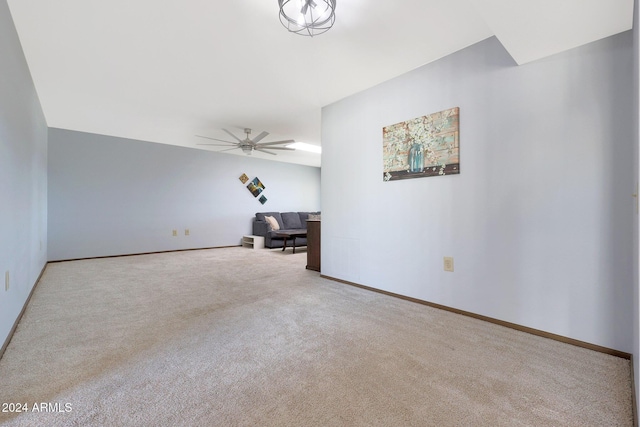 unfurnished living room featuring ceiling fan and light colored carpet