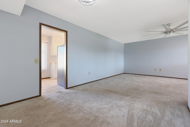 spare room featuring ceiling fan and light colored carpet