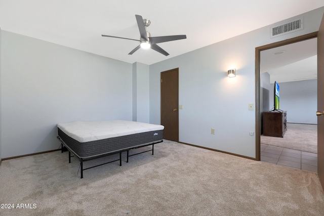 bedroom featuring light carpet and ceiling fan