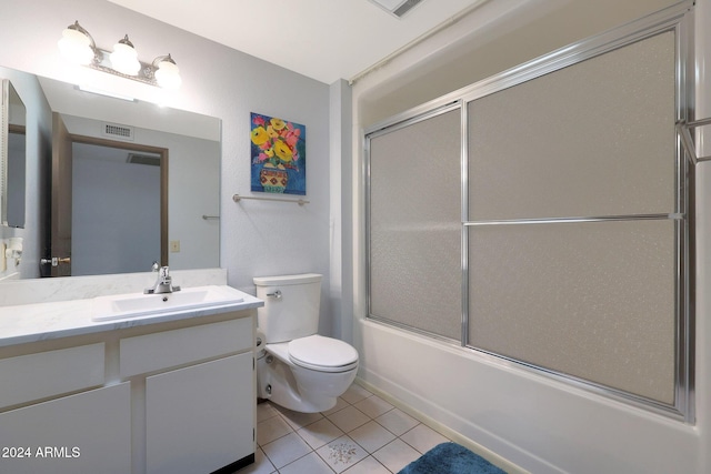 full bathroom featuring tile patterned floors, vanity, enclosed tub / shower combo, and toilet