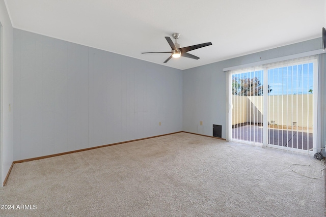 carpeted spare room with ceiling fan