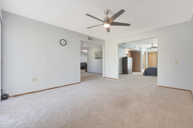 unfurnished bedroom featuring light carpet and ceiling fan