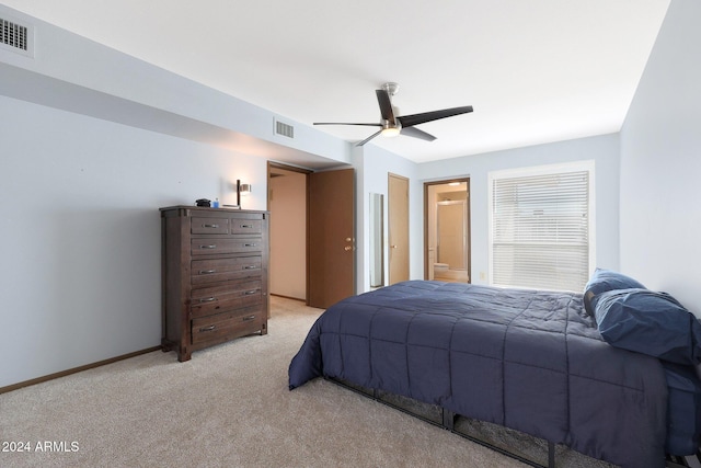 carpeted bedroom featuring ceiling fan and ensuite bathroom