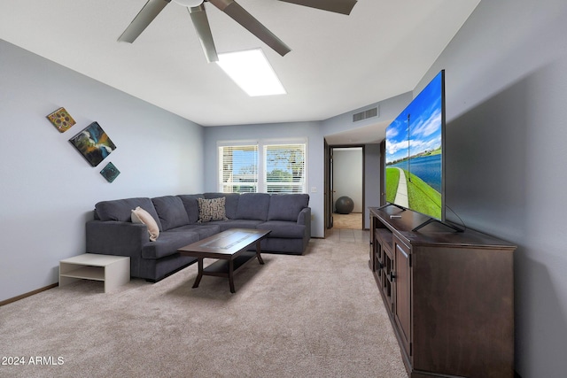 living room featuring light colored carpet and ceiling fan