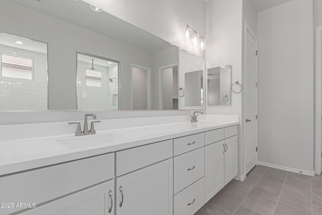 bathroom with tile patterned floors, tiled shower, and vanity