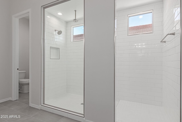 bathroom featuring toilet, tile patterned floors, and walk in shower