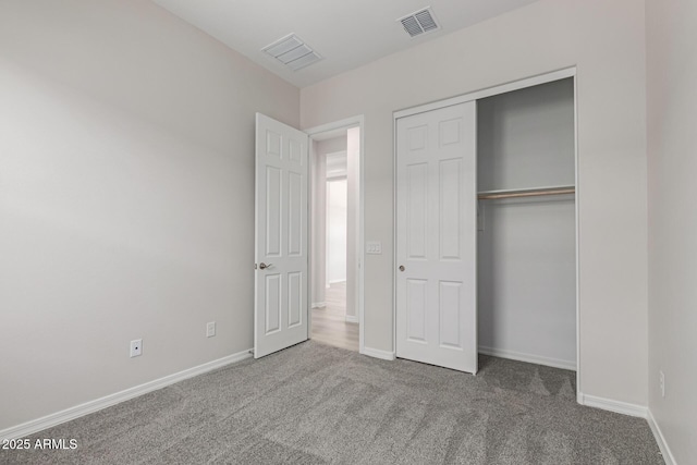 unfurnished bedroom with carpet floors and a closet