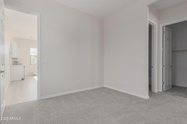 unfurnished bedroom featuring light carpet