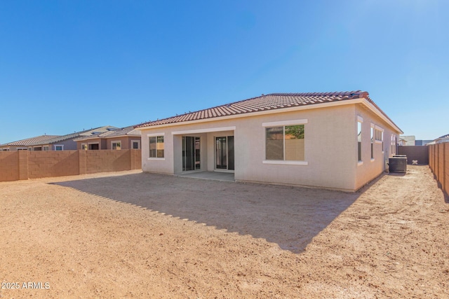 rear view of property featuring a patio area and central AC unit