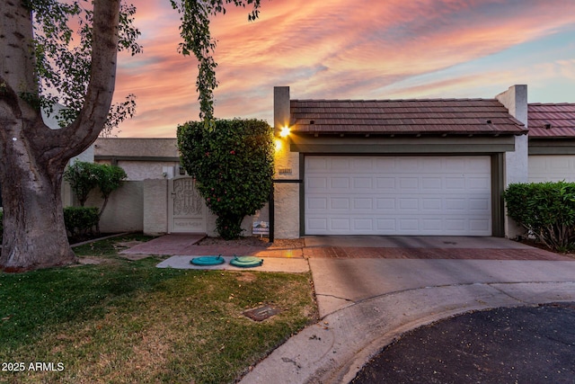 106 E Echo Ln, Phoenix, AZ 85020 - view of front facade with a garage, stucco siding, a front lawn, and driveway