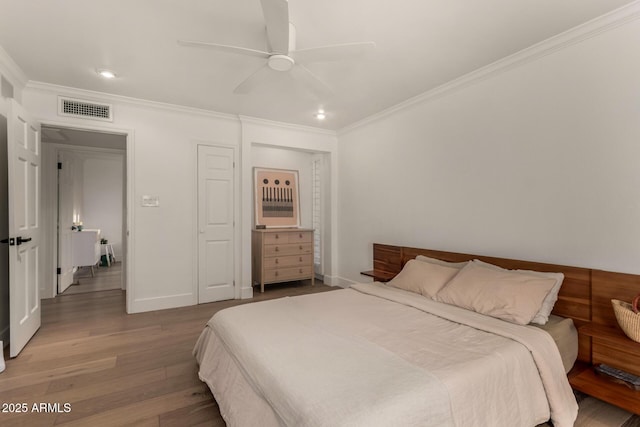 106 E Echo Ln, Phoenix, AZ 85020 - bedroom with baseboards, ornamental molding, visible vents, and wood finished floors