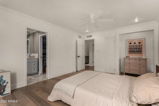 106 E Echo Ln, Phoenix, AZ 85020 - bedroom featuring wood finished floors, ornamental molding, visible vents, connected bathroom, and baseboards