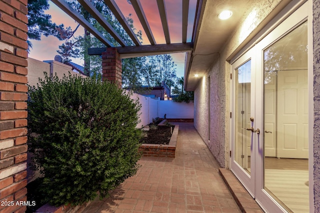 106 E Echo Ln, Phoenix, AZ 85020 - patio terrace at dusk featuring a fenced backyard, a pergola, and french doors