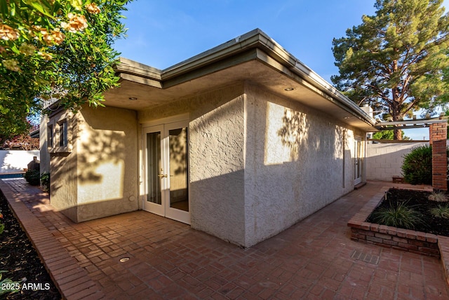 106 E Echo Ln, Phoenix, AZ 85020 - view of home's exterior with a patio area, stucco siding, french doors, and fence