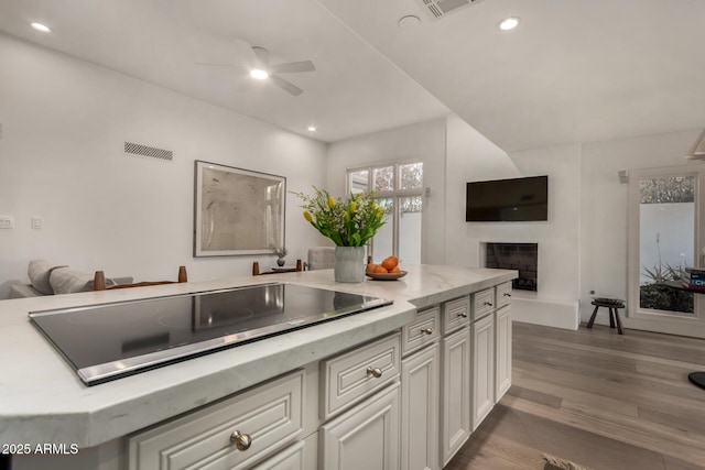 106 E Echo Ln, Phoenix, AZ 85020 - kitchen featuring open floor plan, white cabinetry, dark wood-type flooring, ceiling fan, and black electric stovetop