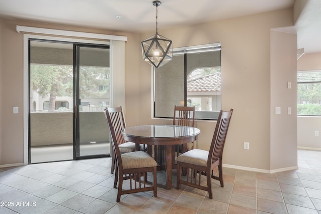 dining space featuring baseboards and light tile patterned floors