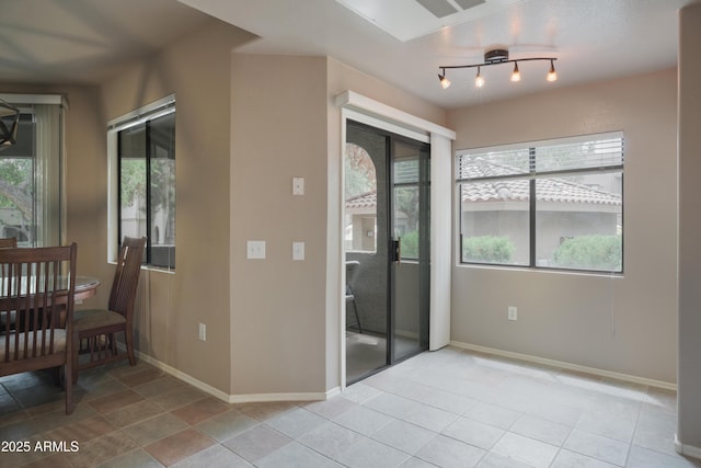 unfurnished room with baseboards and light tile patterned floors