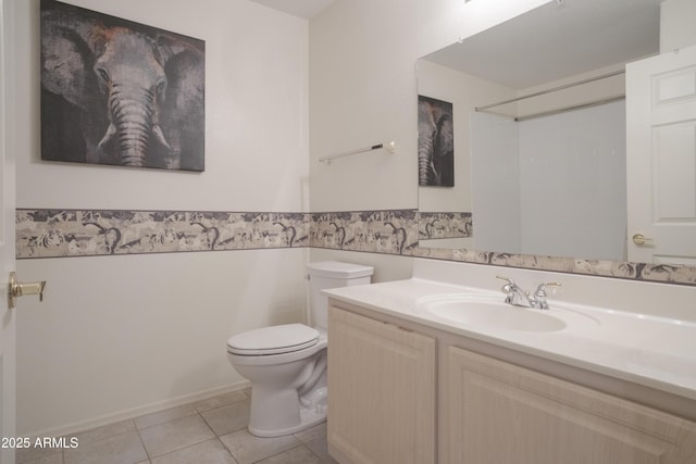 bathroom with tile patterned floors, toilet, and vanity