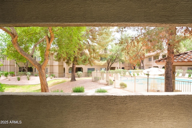 view of yard with a community pool and fence