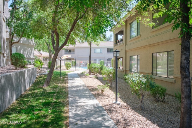 surrounding community with fence and a residential view