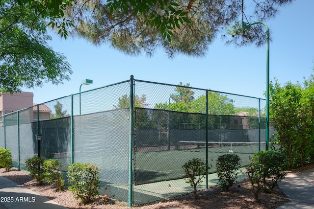 view of tennis court with fence