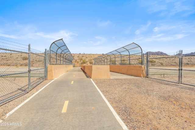 view of street with a gate and a mountain view