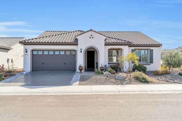 mediterranean / spanish house featuring a garage