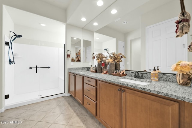 bathroom with vanity, an enclosed shower, and tile patterned floors