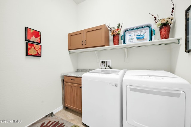 laundry area with light tile patterned flooring, cabinets, and washer and dryer