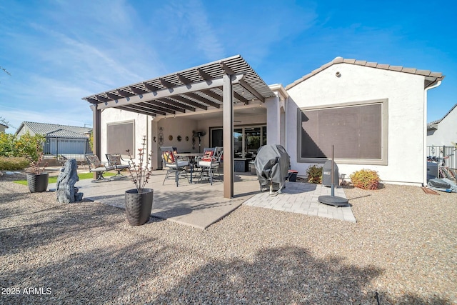 rear view of property with a pergola and a patio