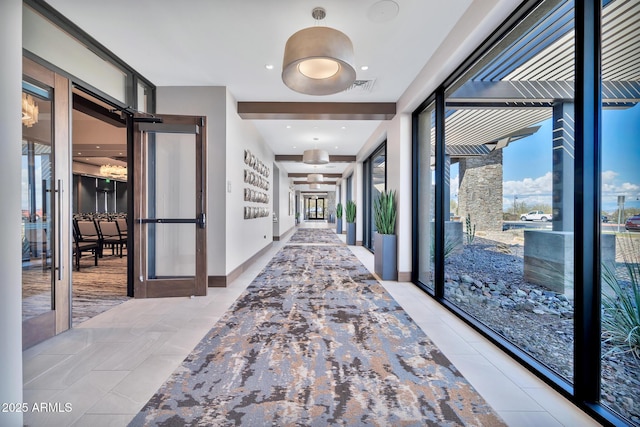 corridor with french doors and light tile patterned flooring