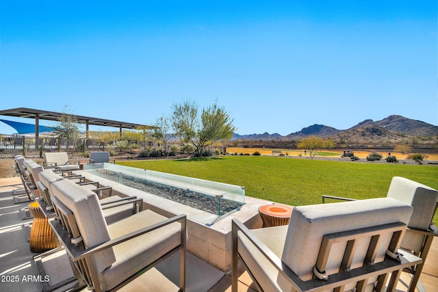 view of patio / terrace featuring a rural view, a mountain view, and an outdoor fire pit