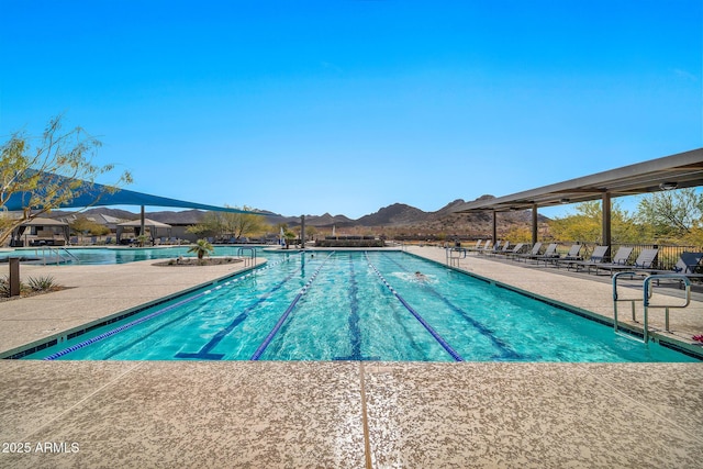 view of pool featuring a mountain view and a patio area