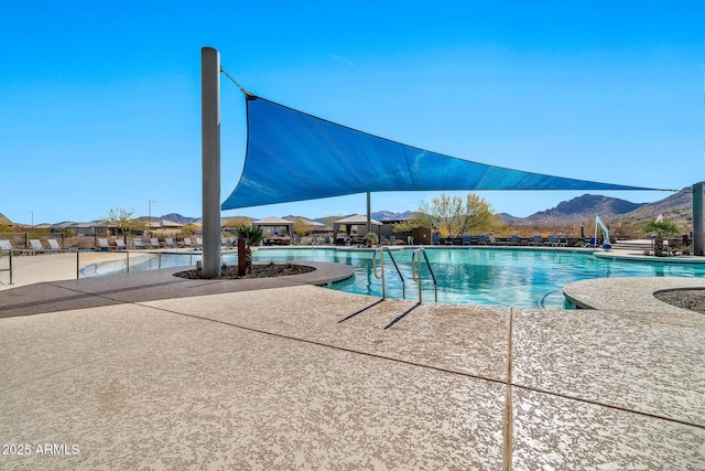 view of pool with a mountain view and a patio