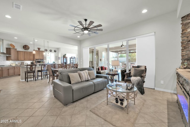 tiled living room featuring ceiling fan