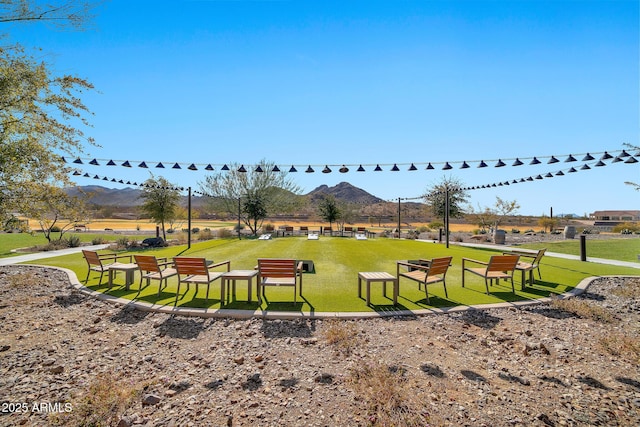 surrounding community featuring a mountain view, a yard, and a rural view