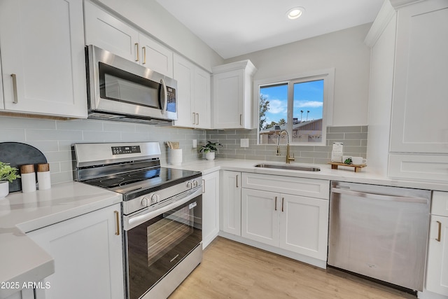 4720 W Northview Ave, Glendale, AZ 85301 - kitchen with appliances with stainless steel finishes, a sink, white cabinetry, light countertops, and light wood finished floors