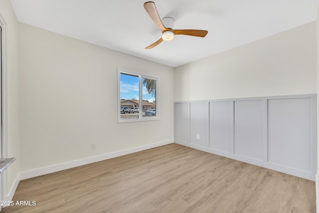 4720 W Northview Ave, Glendale, AZ 85301 - spare room with light wood-style floors, a ceiling fan, a decorative wall, and wainscoting