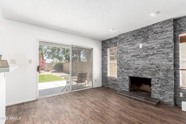 3829 W Camino Del Rio, Glendale, AZ 85310 - unfurnished living room with a textured ceiling, wood finished floors, a tile fireplace, and baseboards