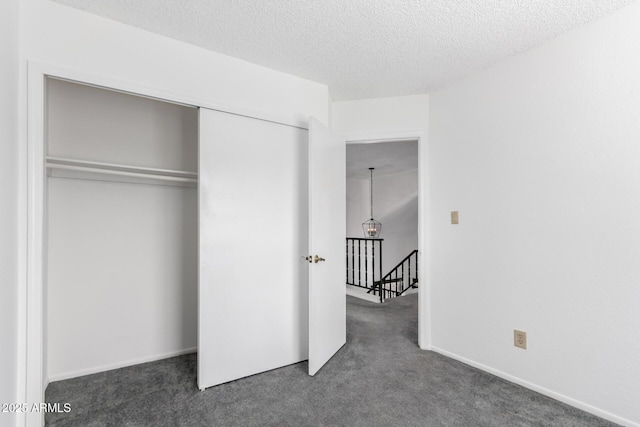 3829 W Camino Del Rio, Glendale, AZ 85310 - unfurnished bedroom with carpet floors, a closet, and a textured ceiling