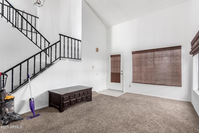 3829 W Camino Del Rio, Glendale, AZ 85310 - carpeted foyer featuring high vaulted ceiling, stairway, and baseboards