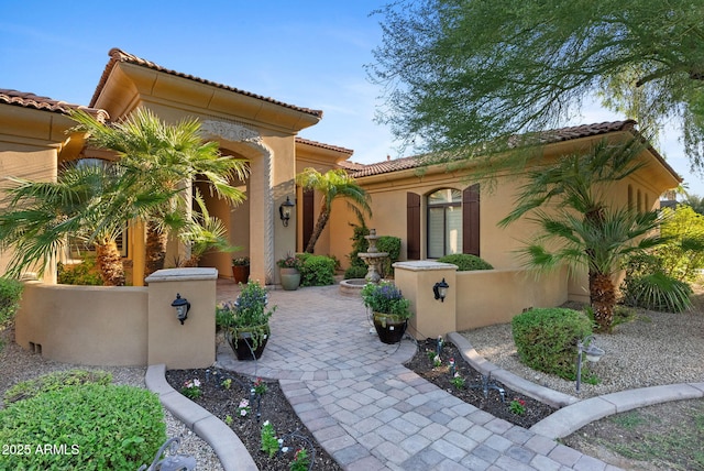 view of front of property with a tiled roof and stucco siding