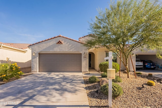 mediterranean / spanish-style home with a garage