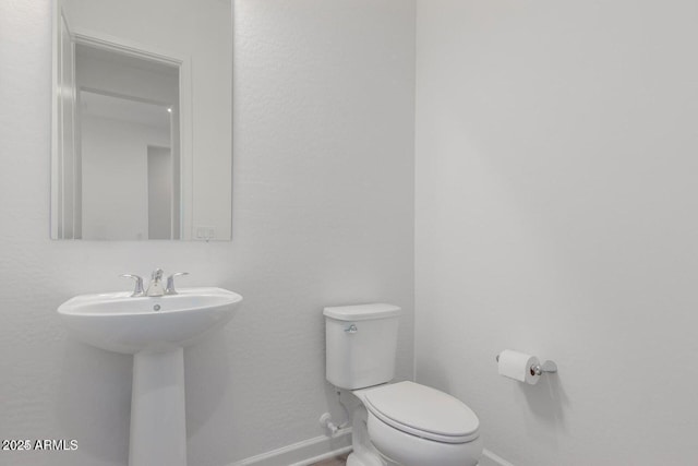 bathroom featuring sink and toilet