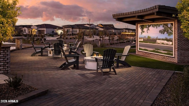 patio terrace at dusk featuring a fire pit