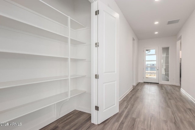 hallway featuring wood-type flooring