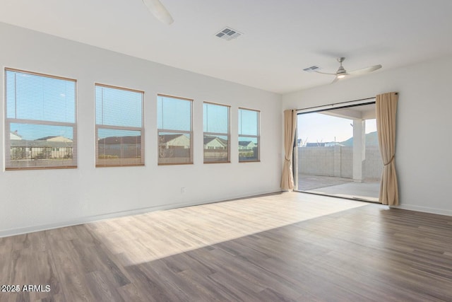 unfurnished room with hardwood / wood-style floors and ceiling fan